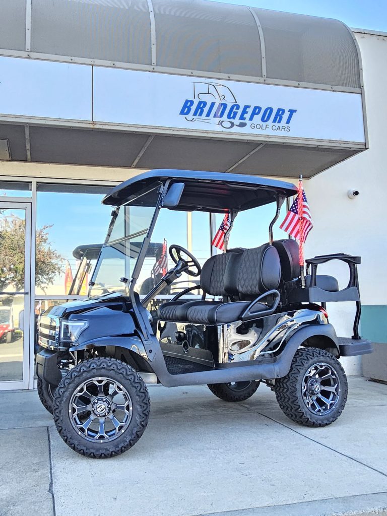 black trimmed four seater golf car outside the Bridgeport Golf Cars showroom