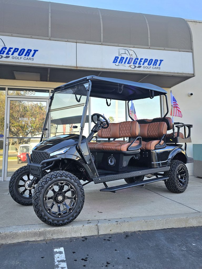 black and leather six seater golf car outside the Bridgeport Golf Cars showroom