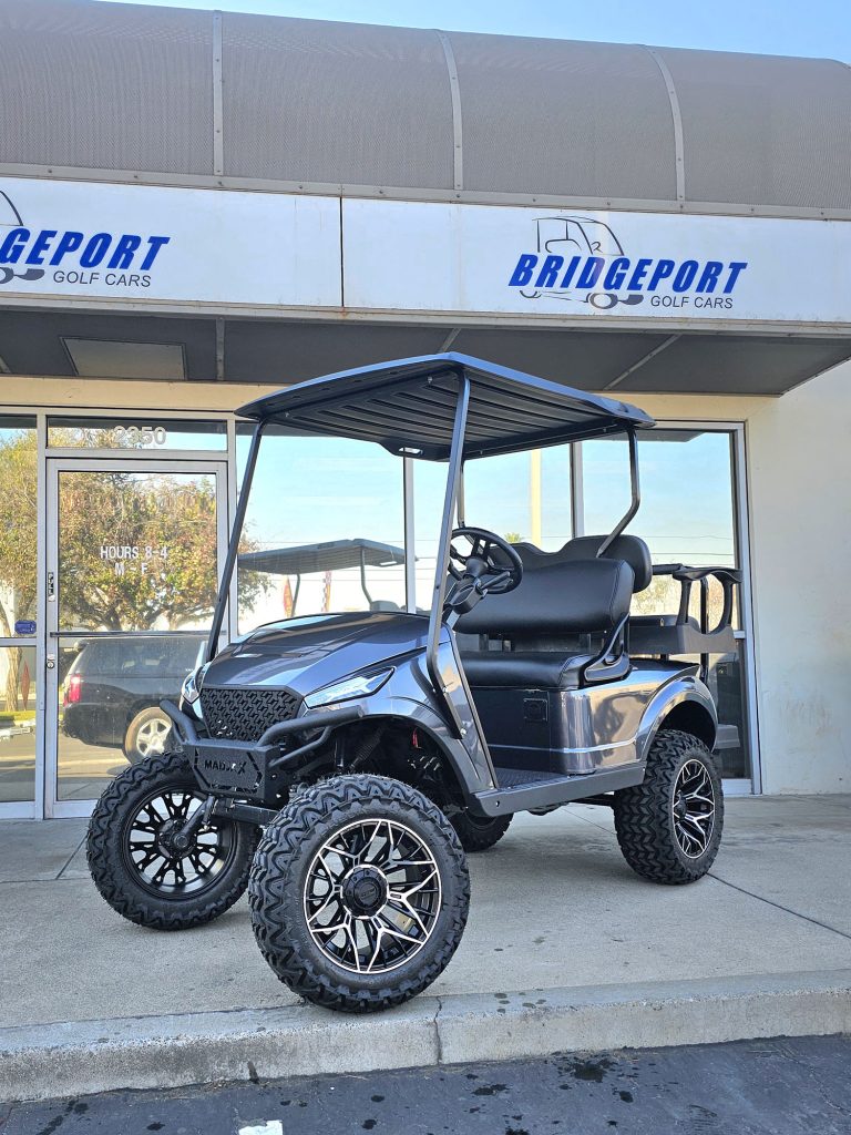 silver trimmed four seater golf car outside the Bridgeport Golf Cars showroom